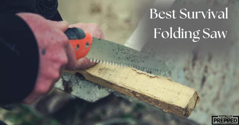 best survival folding saw - Totally Prepped man using survival folding saw on piece of wood